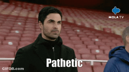 A Man Sitting In A Stadium With The Word Pathetic On The Screen GIF
