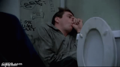 A Man Sitting In A Toilet With Graffiti On The Wall Behind Him That Says Bye And Let GIF