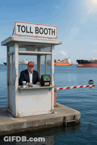 A Man Sitting In A Toll Booth With A Stop Sign In Front Of Him GIF