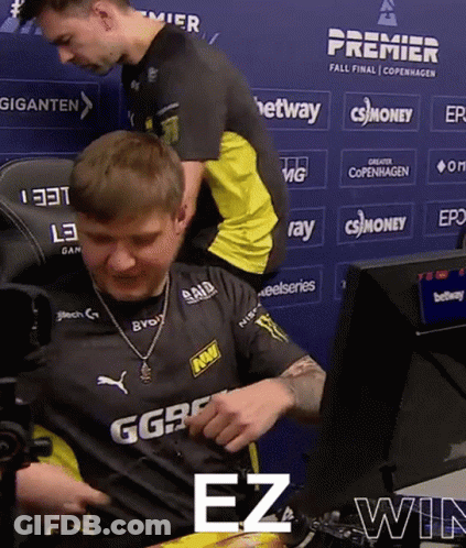 A Man Sitting In Front Of A Blue Wall That Says Premier Fall Final Copenhagen On It GIF