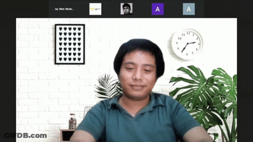 A Man Sitting In Front Of A Clock With The Letters A And A On The Bottom Right GIF