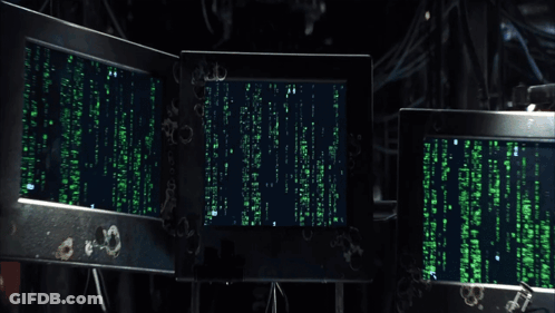 A Man Sitting In Front Of A Computer Screen That Says " Matrix " On It GIF