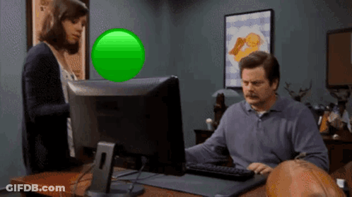 A Man Sitting In Front Of A Computer With A Green Screen GIF