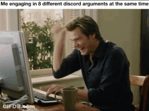 A Man Sitting In Front Of A Computer With A Mug In Front Of Him GIF