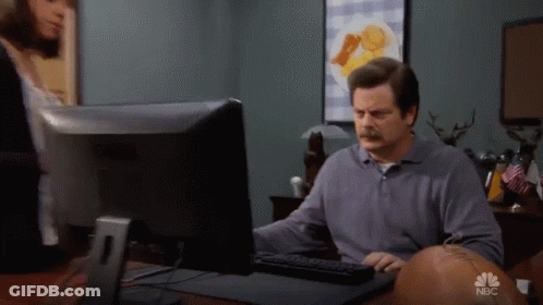 A Man Sitting In Front Of A Computer With Nbc Written On The Bottom GIF