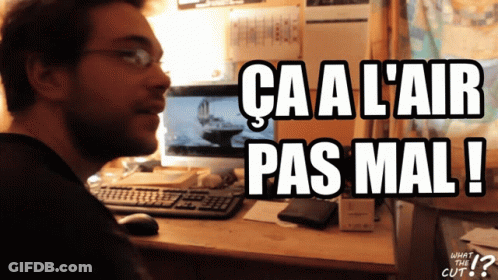 A Man Sitting In Front Of A Computer With The Words Ca A L' Air Pas Mal Written Below Him GIF