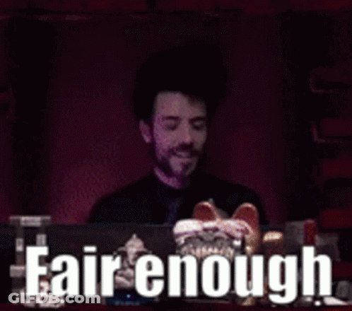 A Man Sitting In Front Of A Computer With The Words Fair Enough Written On The Screen Behind Him GIF