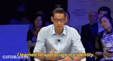 A Man Sitting In Front Of A Crowd With The Words " I Learned To Appreciate My Identity " GIF