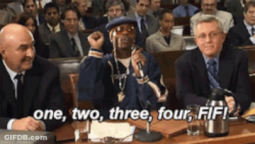 A Man Sitting In Front Of A Crowd With The Words One Two Three Four Fifi GIF