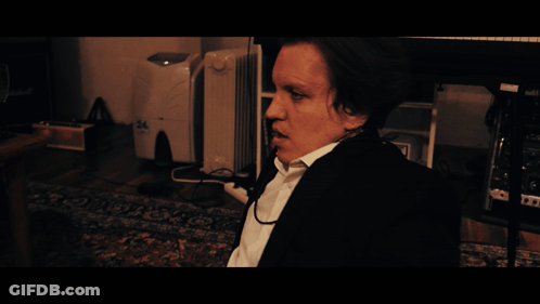 A Man Sitting In Front Of A Desk With The Word Monday On It GIF