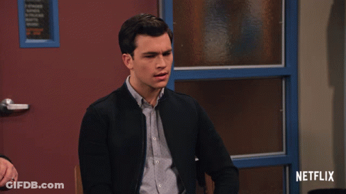 A Man Sitting In Front Of A Door With Netflix Written On The Bottom GIF