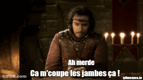 A Man Sitting In Front Of A Fireplace With The Words Ah Merde Ca M 'Coupe Les Jambes Ca GIF