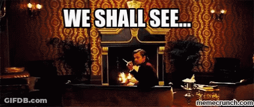 A Man Sitting In Front Of A Fireplace With The Words " We Shall See " Written Above Him GIF