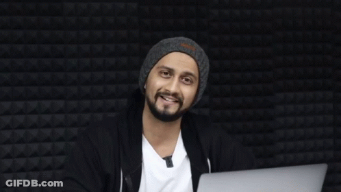 A Man Sitting In Front Of A Laptop With The Word Haha On The Bottom Right GIF