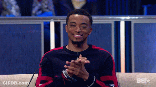 A Man Sitting In Front Of A Microphone With A Bet Logo On The Bottom GIF