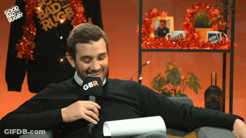 A Man Sitting In Front Of A Microphone With Gbr On It GIF