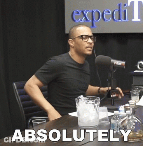 A Man Sitting In Front Of A Microphone With The Word Absolutely Written On The Bottom GIF
