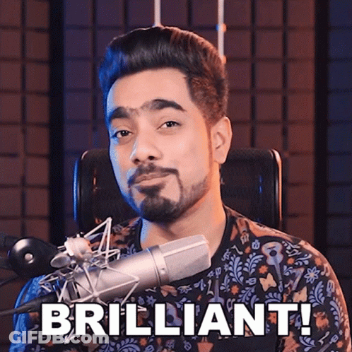 A Man Sitting In Front Of A Microphone With The Words " Brilliant " Written On His Face GIF