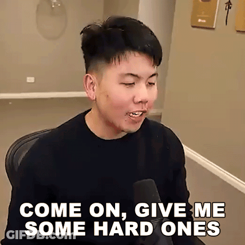 A Man Sitting In Front Of A Microphone With The Words Come On Give Me Some Hard Ones Written Below Him GIF
