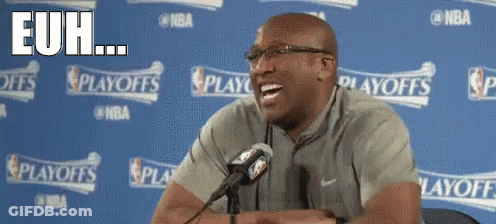 A Man Sitting In Front Of A Microphone With The Words " Euh " On The Bottom Right GIF
