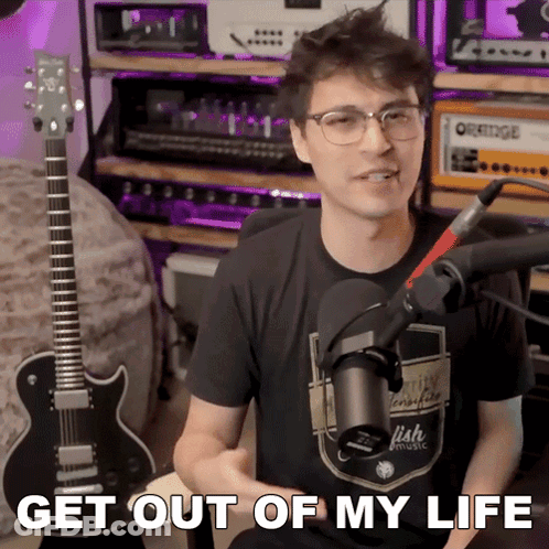Man Sitting In Front Of Microphone Saying Get Out Of My Life GIF