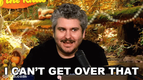 A Man Sitting In Front Of A Microphone With The Words I Can 'T Get Over That GIF