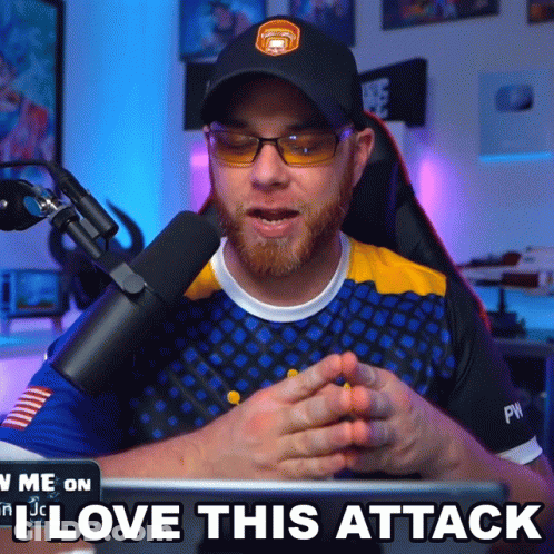 A Man Sitting In Front Of A Microphone With The Words " I Love This Attack " Below Him GIF