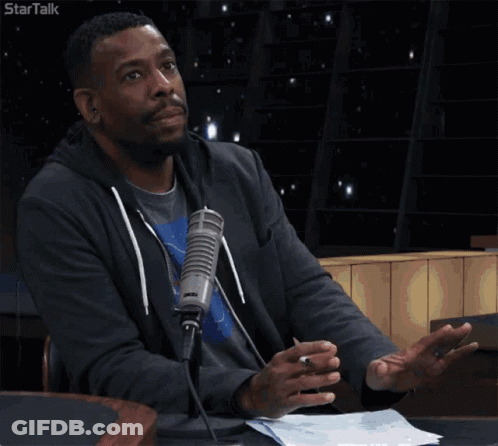 A Man Sitting In Front Of A Microphone With The Words I 'M Just Saying GIF