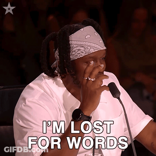 A Man Sitting In Front Of A Microphone With The Words I 'M Lost For Words GIF