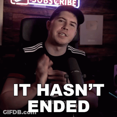 A Man Sitting In Front Of A Microphone With The Words " It Hasn 'T Ended " Below Him GIF