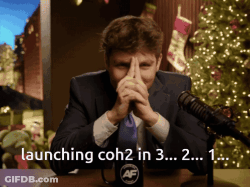 A Man Sitting In Front Of A Microphone With The Words Launching Coh2 In 3 In The Corner GIF