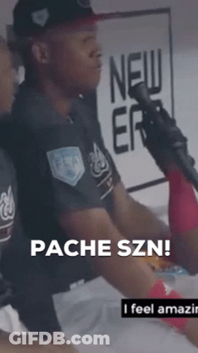 A Man Sitting In Front Of A Microphone With The Words " Pacheszn " On The Bottom Right GIF