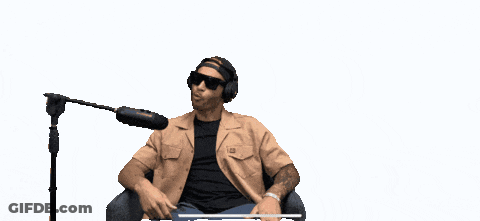A Man Sitting In Front Of A Microphone With The Words " People Are Fucking Lazy " Above Him GIF