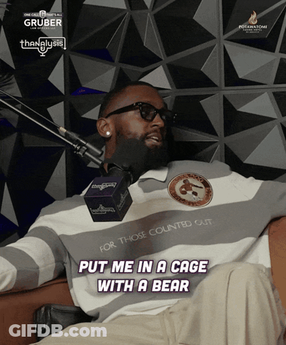 A Man Sitting In Front Of A Microphone With The Words Put Me In A Cage With A Bear On The Bottom GIF
