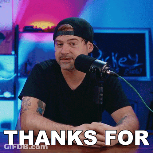 A Man Sitting In Front Of A Microphone With The Words Thanks For Written Underneath Him GIF