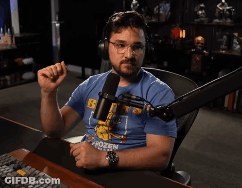 A Man Sitting In Front Of A Microphone With The Words Very Unimpressed Applause Written Below Him GIF