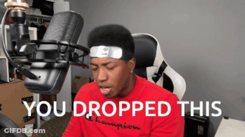 A Man Sitting In Front Of A Microphone With The Words " You Dropped This " On The Bottom GIF