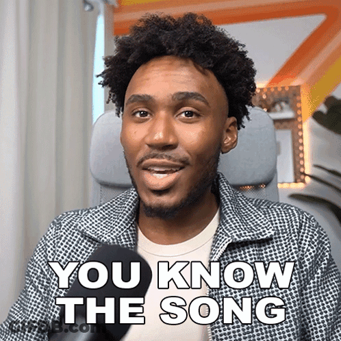 A Man Sitting In Front Of A Microphone With The Words " You Know The Song " On His Face GIF