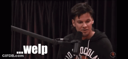 A Man Sitting In Front Of A Microphone With Welp Written On The Screen Behind Him GIF
