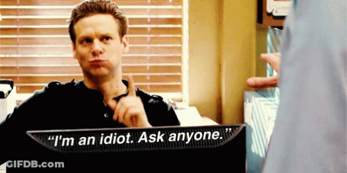 A Man Sitting In Front Of A Monitor That Says I 'M An Idiot Ask Anyone GIF
