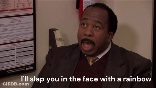 A Man Sitting In Front Of A Poster That Says I 'Ll Slap You In The Face With A Rainbow On It GIF