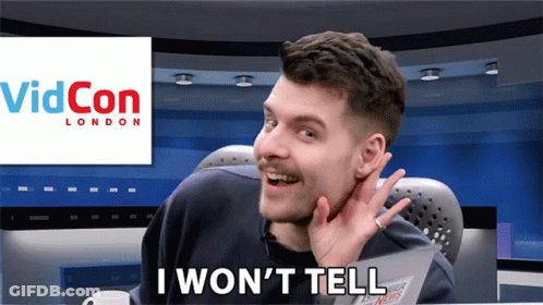 A Man Sitting In Front Of A Screen That Says " I Won 'T Tell " GIF