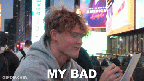 A Man Sitting In Front Of A Sign That Says America Eagle GIF