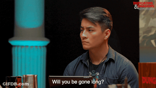 A Man Sitting In Front Of A Sign That Says Dungeons & Dragons GIF