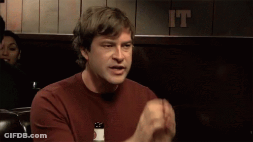 A Man Sitting In Front Of A Sign That Says It Is Decided On It GIF