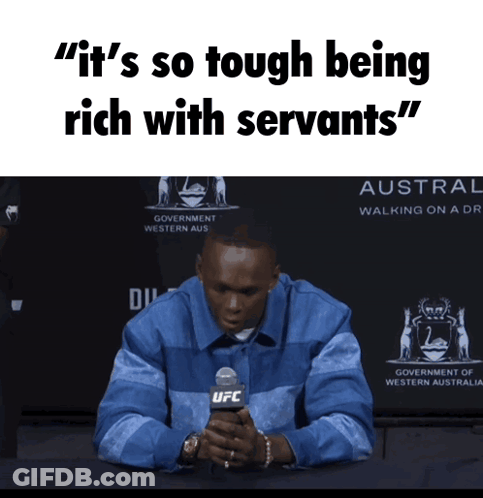 A Man Sitting In Front Of A Sign That Says ' It 'S So Tough Being Rich With Servants " GIF