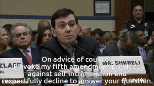 A Man Sitting In Front Of A Sign That Says On Advice Of Counsel GIF