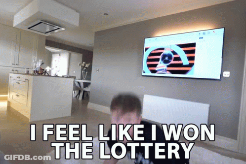 A Man Sitting In Front Of A Television With The Words " I Feel Like I Won The Lottery " Above Him GIF