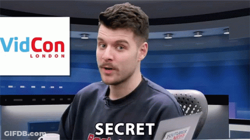 A Man Sitting In Front Of A Videocon London Sign GIF