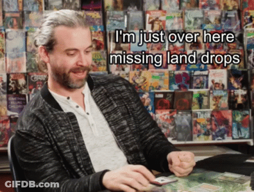 A Man Sitting In Front Of A Wall Of Comic Books With The Words I 'M Just Over Here Missing Land Drops Above Him GIF